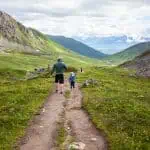 boy and man walking away from camera hatcher pass alaska summer