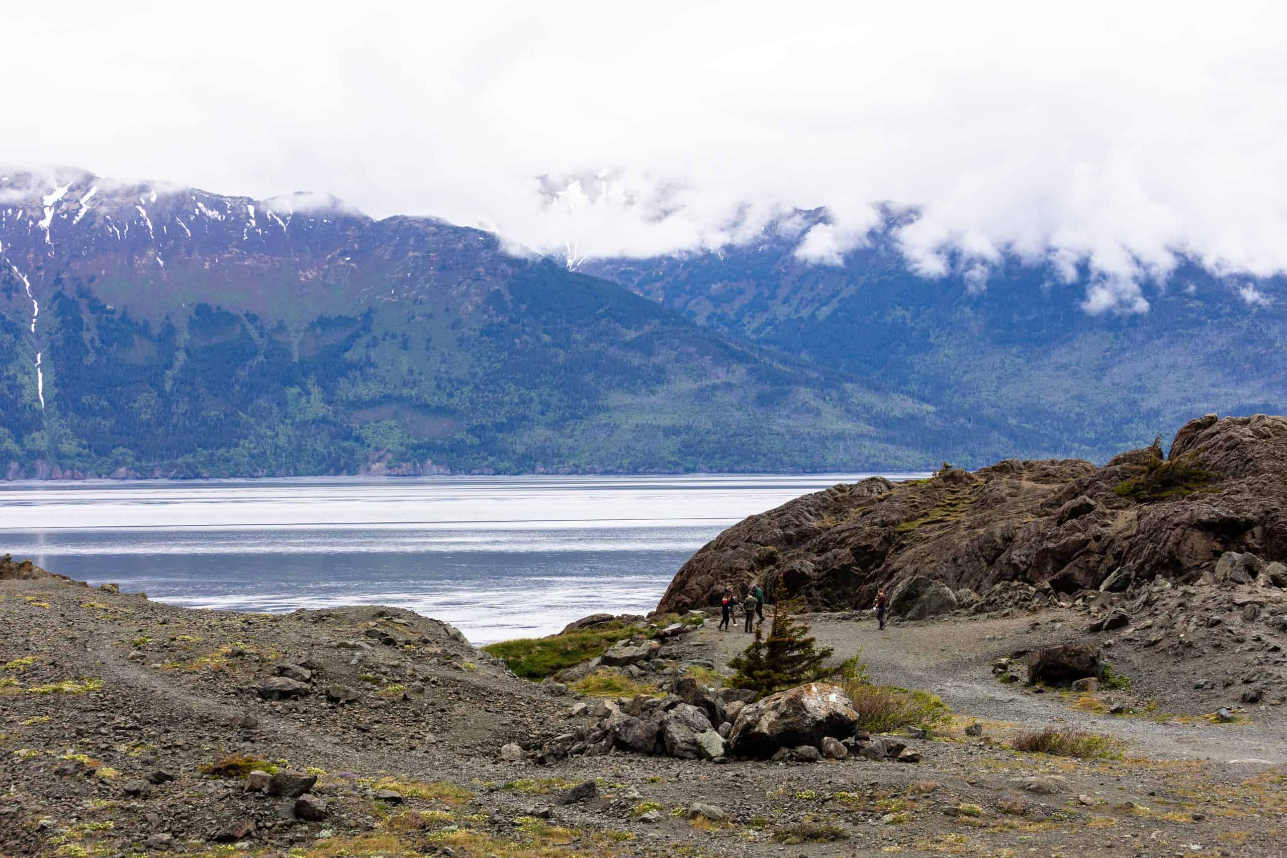 beluga point along turnagain arm image with land in foreground and mountains in background summer moody and pretty day